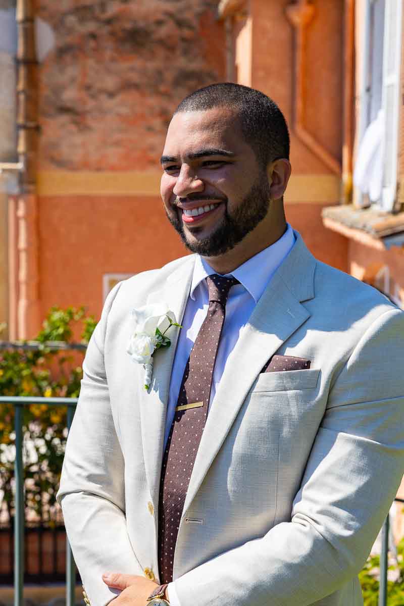 Smiling groom photography during the ceremony