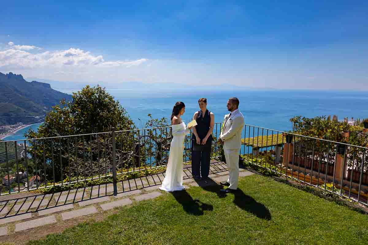 Exchanging vows during the marriage elopement using the coast as background