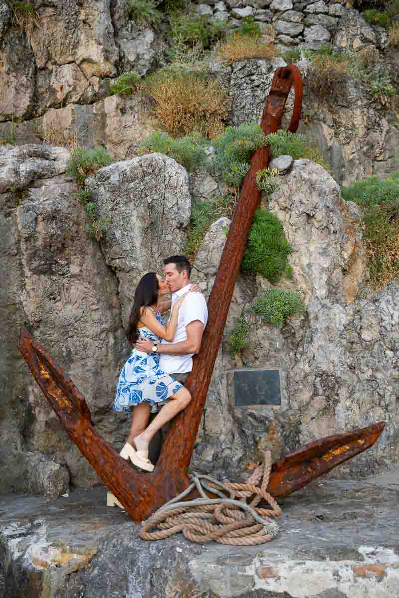 Taking picture on an anchor a rusted one set against a cliff