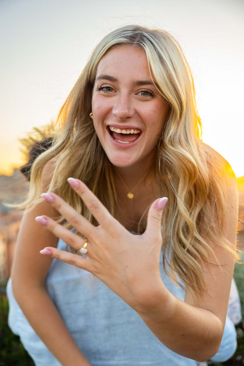 Piggy back ride showing off the engagement ring while enjoying the moment during the photo shoot in Italy