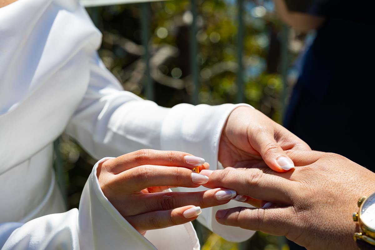 Close up photography of the ring being placed on the hand in order to be married