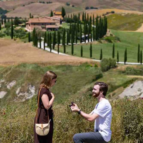 Proposing on a scenic viewpoint called Baccoleno found deep in the Val d’Orcia countryside with a professional photographer taking pictures from afar using a long telephoto lens