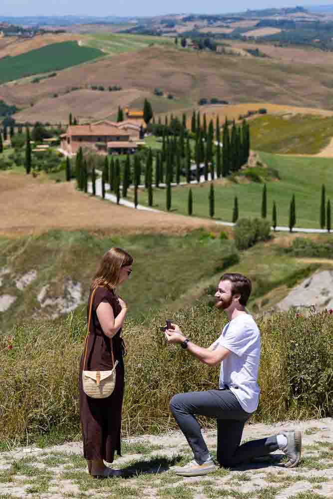 Proposing on a scenic viewpoint called Baccoleno found deep in the Val d’Orcia countryside with a professional photographer taking pictures from afar using a long telephoto lens