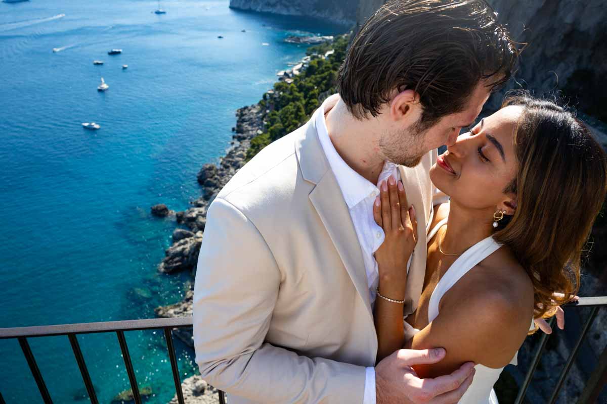 In love kissing close up photography over the stunning image of beautiful seawater