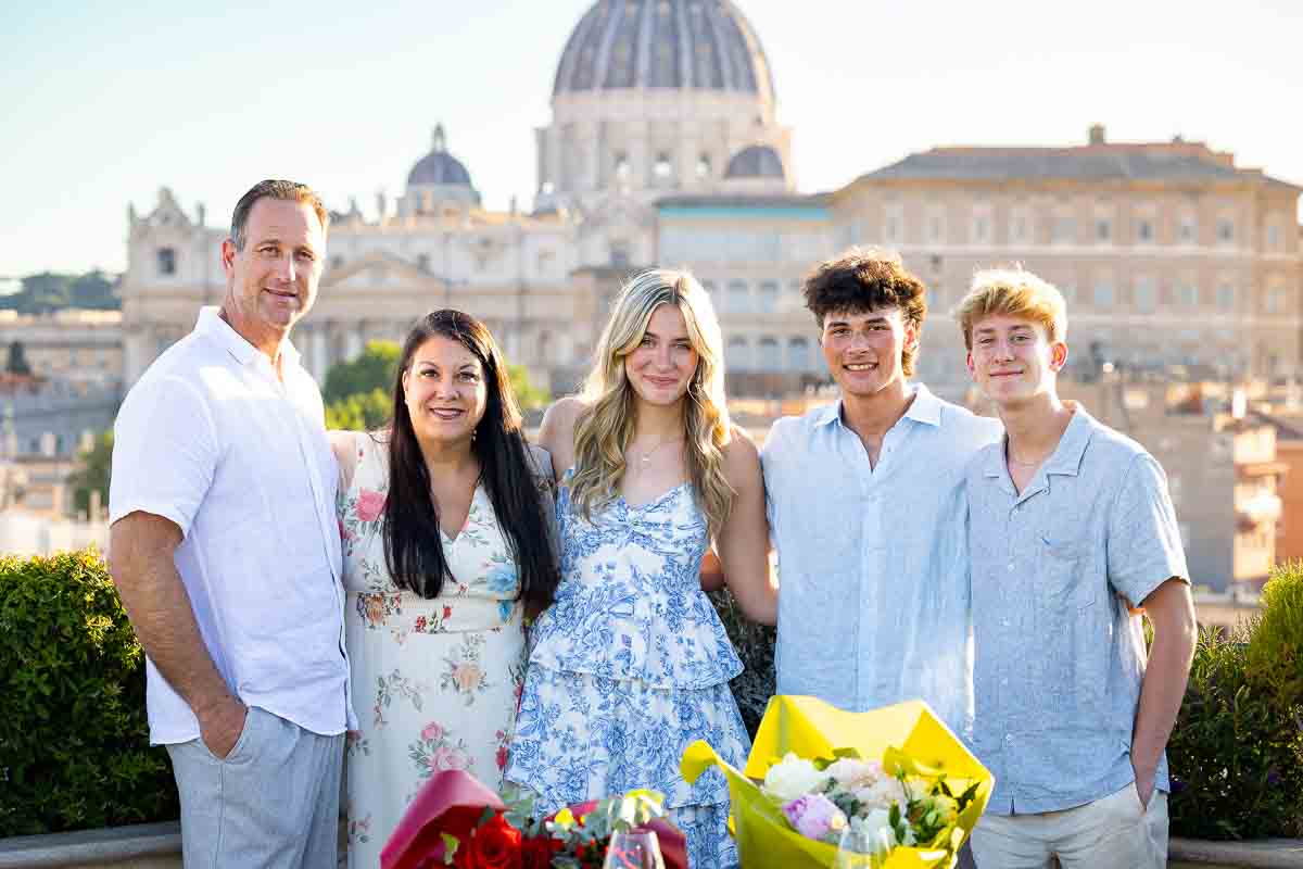 Family photography portrait taken on the a beautiful terrace with a unique view of the rome cityscape
