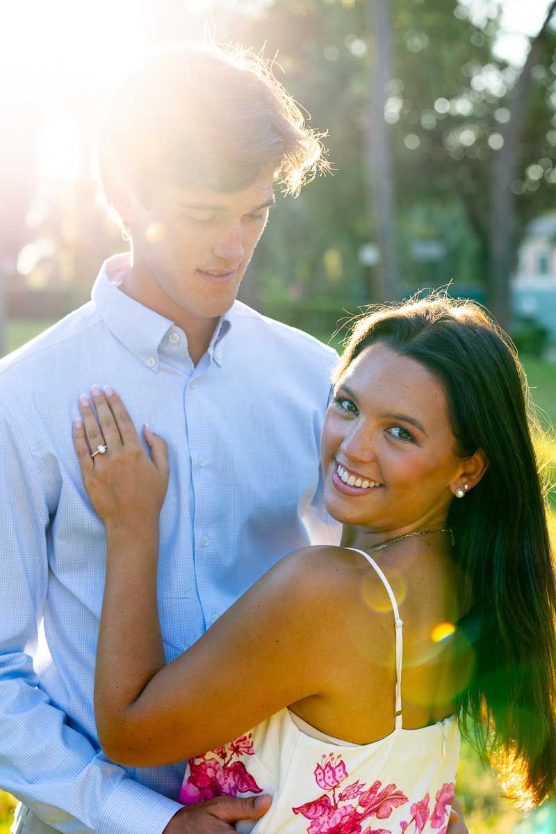 looking back into the camera and smiling during a photoshoot celebrating engagement