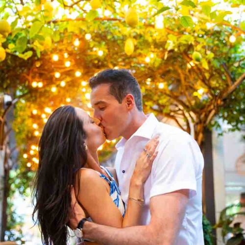 Kissing under warm colored street light lighting up the scene