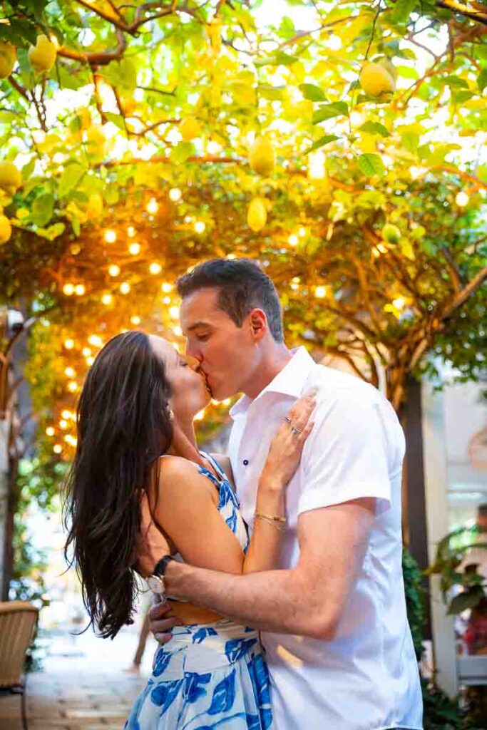 Kissing under warm colored street light lighting up the scene
