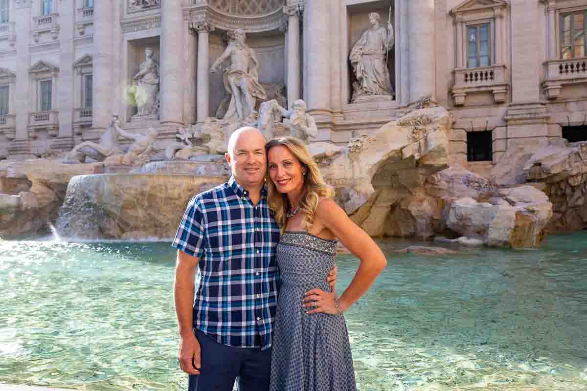 Wide angle couple portrait standing before the azure and blue cobalt water