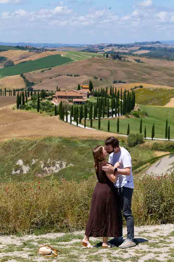 Kissing as the are just engaged in Italian landscape typical of this region 