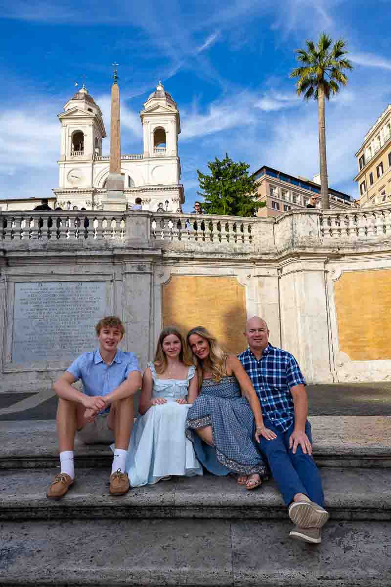 Sitting down in Piazza di Spagna while taking photos next to one another sitting down photography