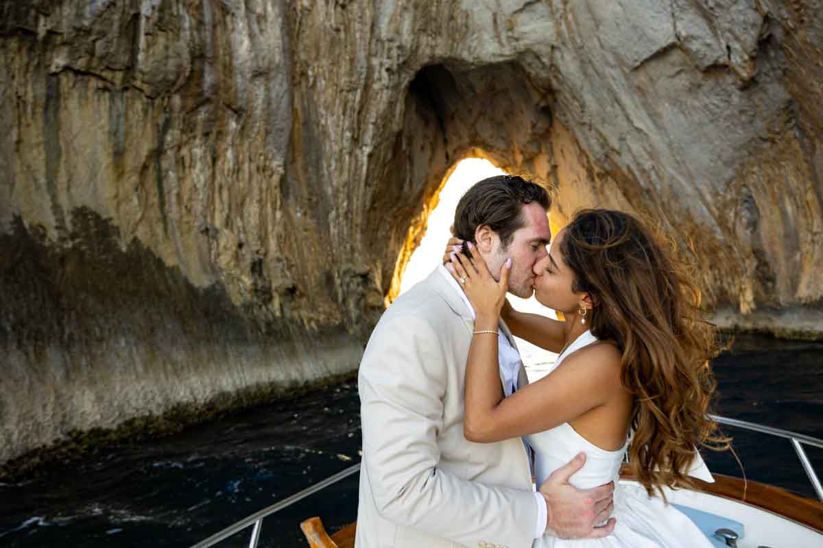 Romantic kiss while closing in towards the rocks