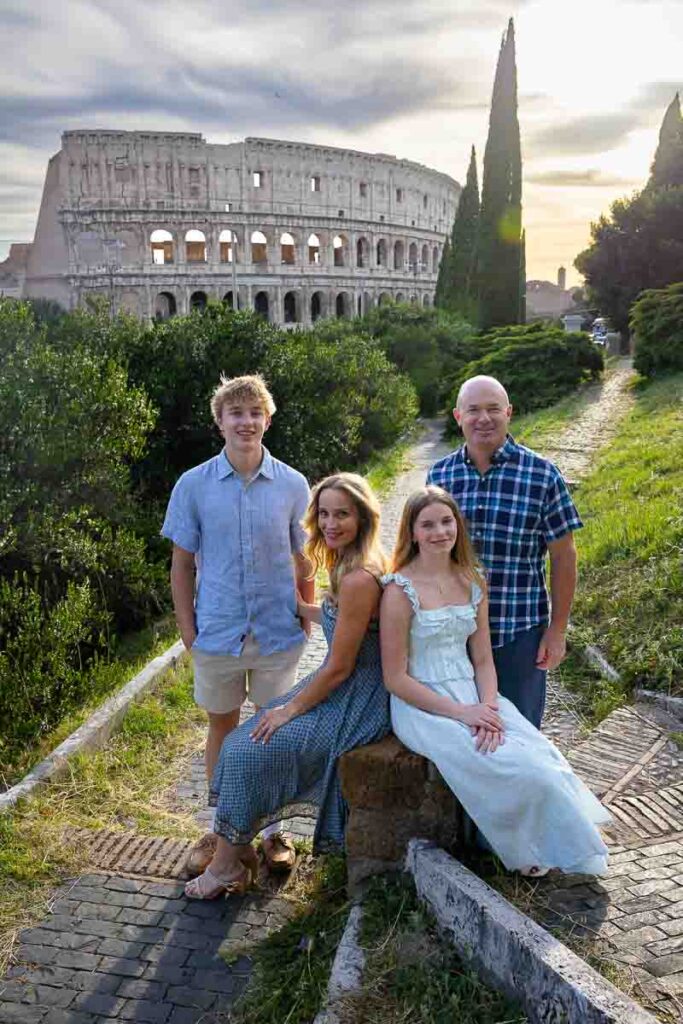 Family photography portrait picture at sunset of a group using a marble roman stump to sit down and create a nice posed image at dusk. Professional photography session