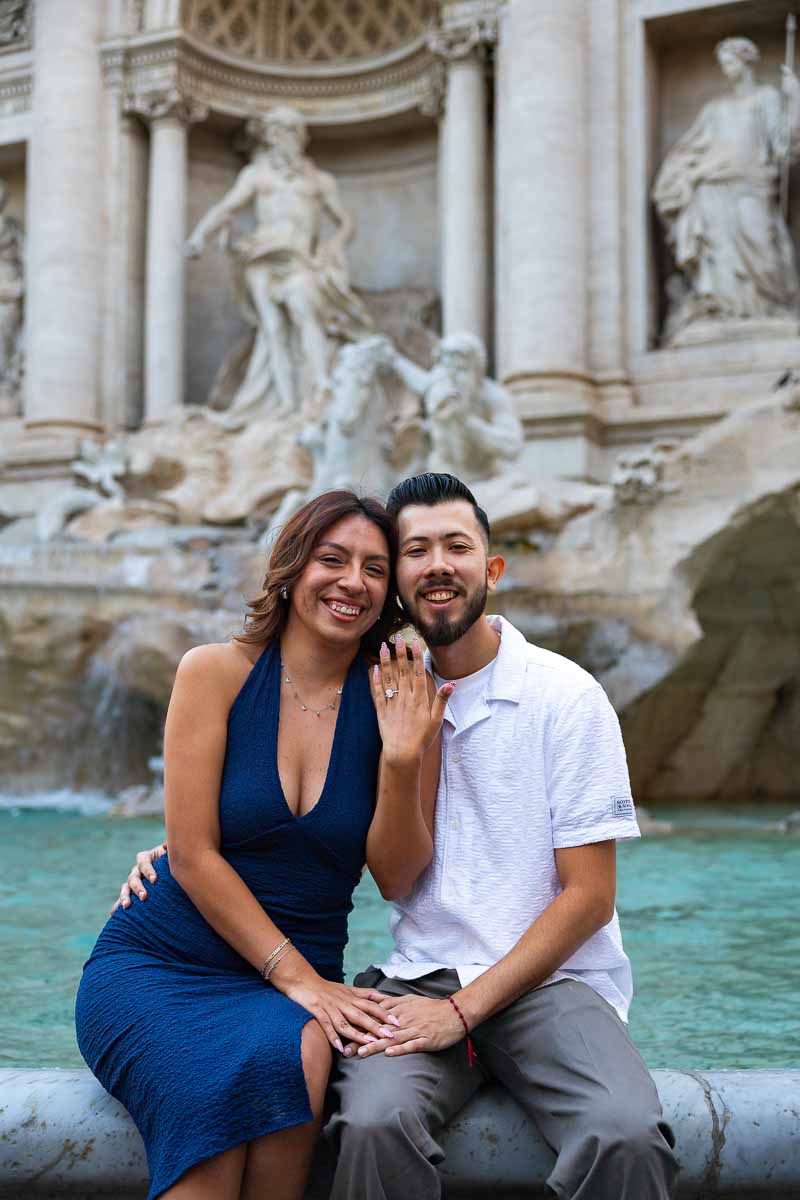 Close portrait highlighting the newly gifted diamond ring, with the hand positioned naturally against the detailed surroundings, captured through a refined engagement photography style.