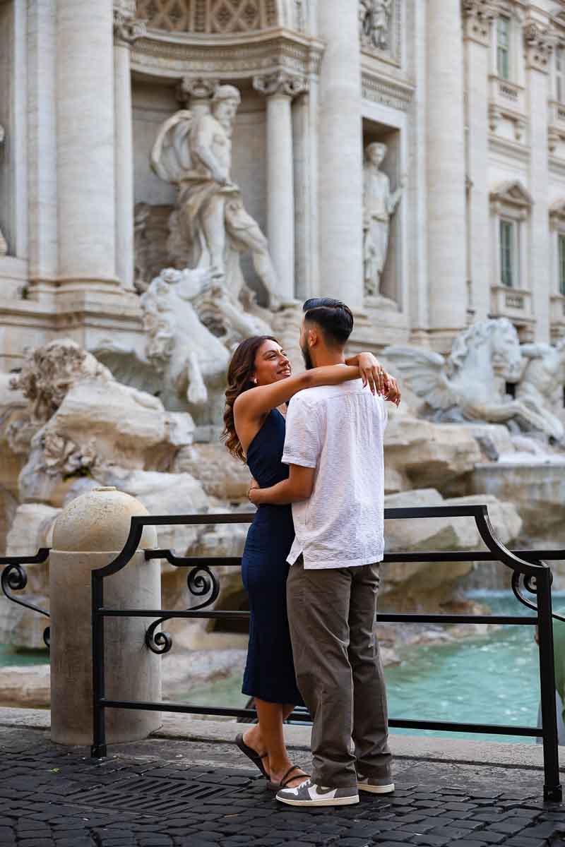 Couple portrait photoshoot session beside the fountain with a relaxed pose, capturing their connection through natural engagement photography with the historic surroundings adding depth to the image.