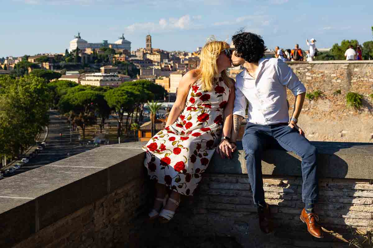 Couple kissing during their engagement photos after having been proposed to in a famous garden park view 