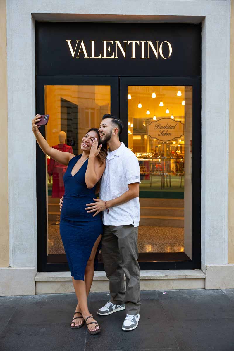 Engaged couple taking a selfie together while celebrating their new commitment, with the diamond ring visible in the frame and a candid lifestyle photography approach capturing the happiness of the moment.