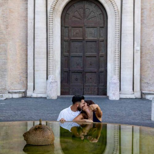 Couple portrait reflecting beside a tranquil water fountain, captured through a serene visual composition with natural tones and a refined engagement photoshoot style.
