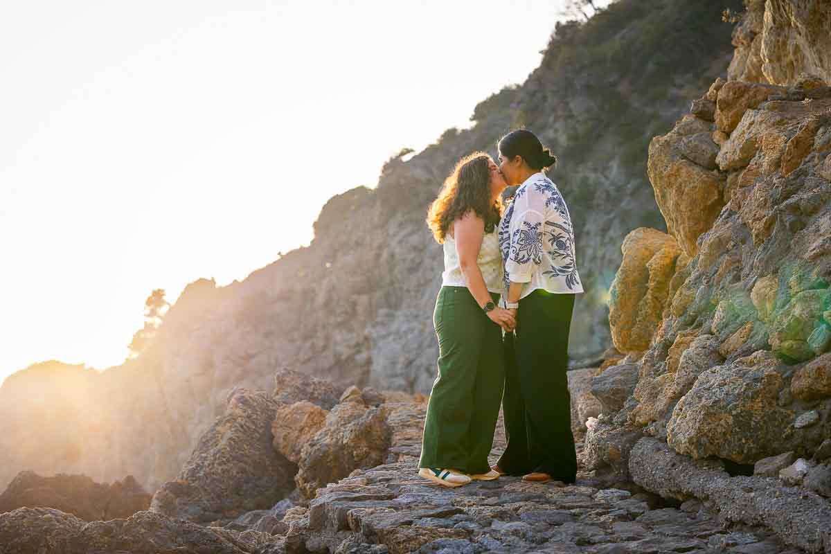 Romantic portrait photography of two women sharing a quiet moment together after getting engaged on the Tuscan coast, surrounded by the natural beauty of this beach side spot