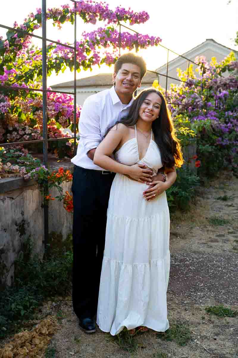 Sunset portrait with sunlight passing through next to bougainvillea fuchsia flowers photography session