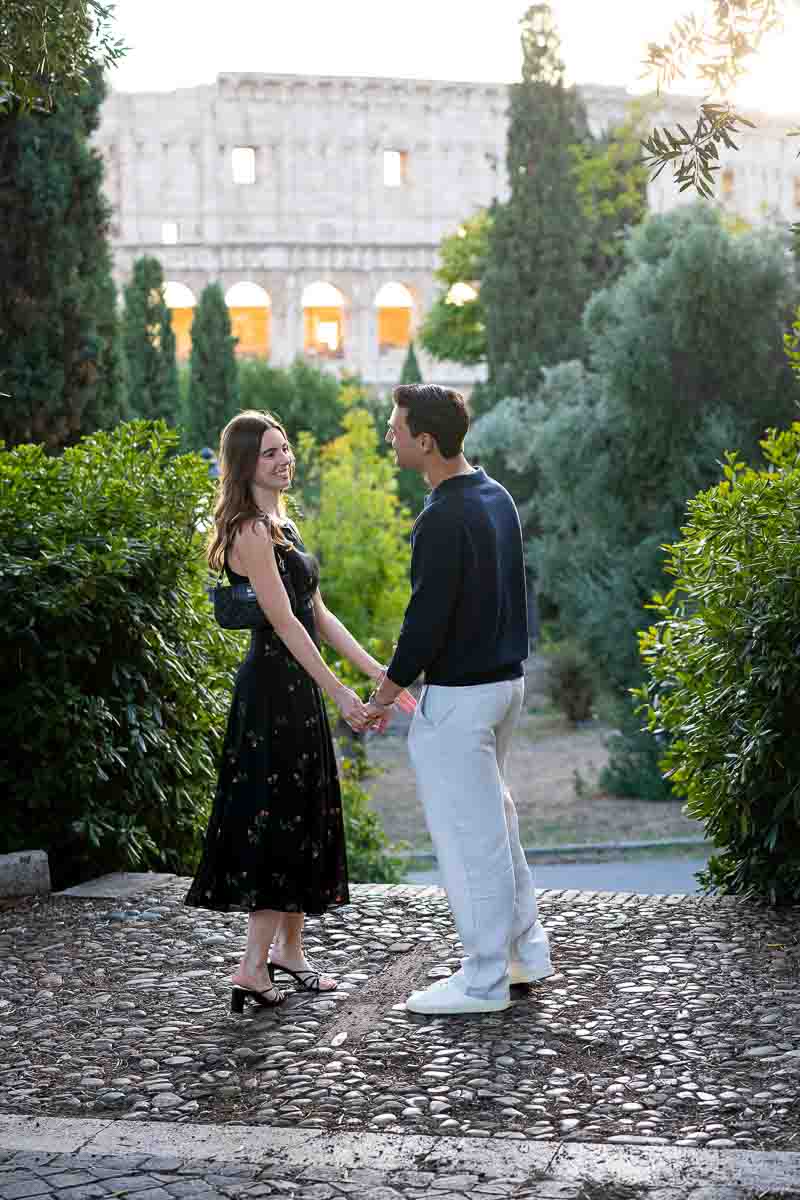Standing facing one another looking at each other just before the big question candidly shot from a distance as part of a photoshoot in Rome