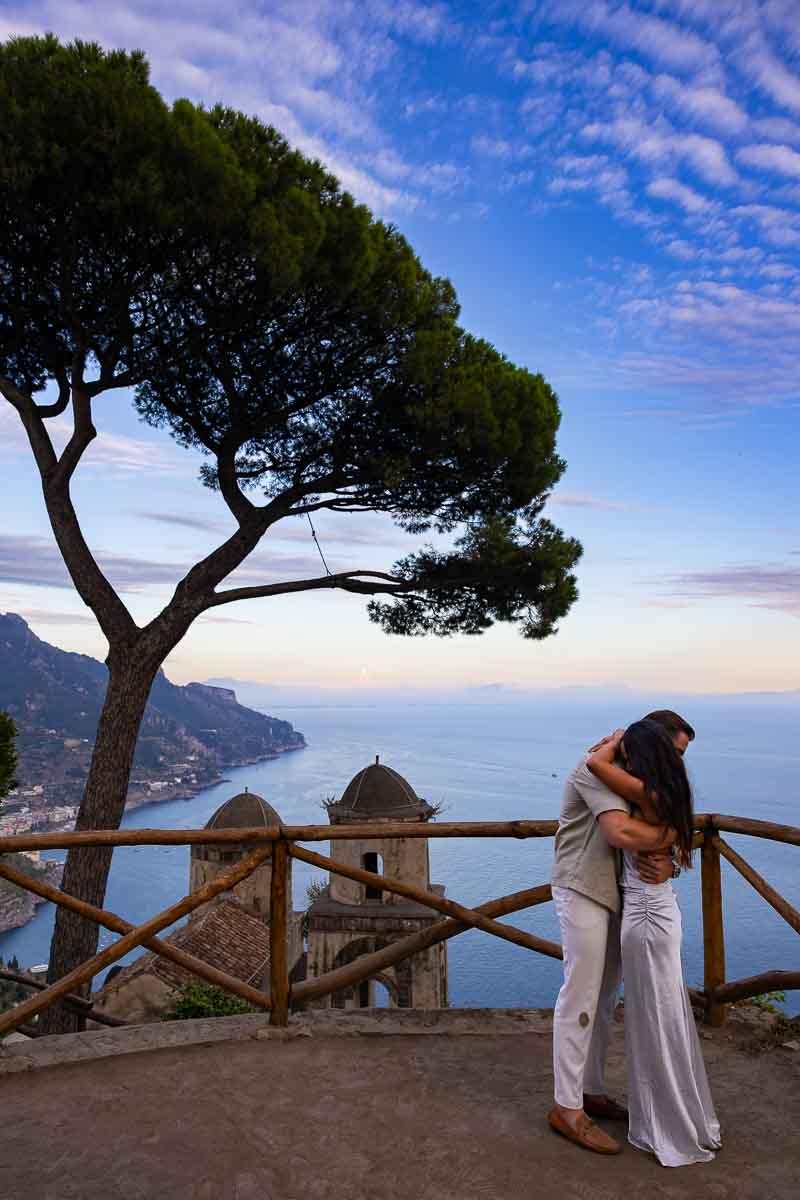 An emotional embrace immediately following a heartfelt yes during a surprise marriage proposal on the cliffs of Ravello.