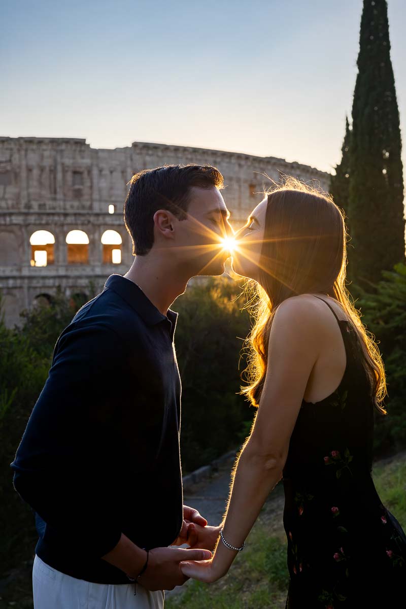The sun framed while setting in between the couple kissing to obtain a unique and creative photographic effect which frames nicely as a picture memory of this important event