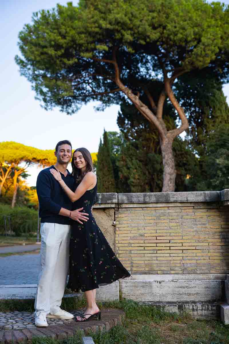 Standing at the base of a park with tall Mediterranean pine trees in the backdrop for unique travel photography