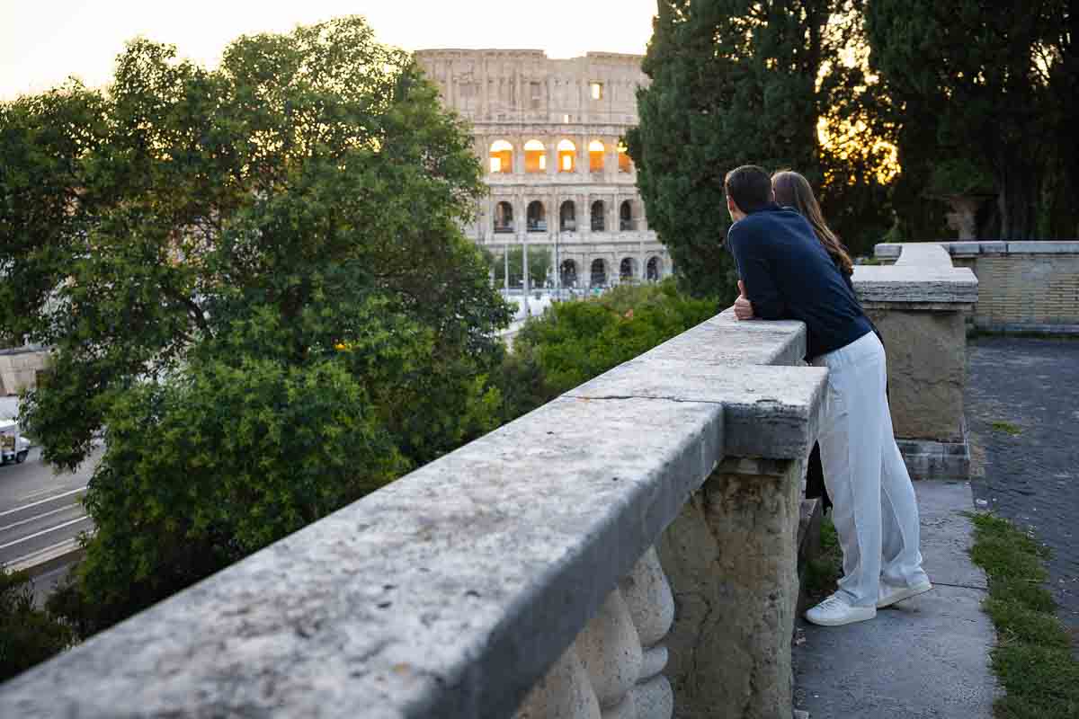 Admiring the view of the Coliseum from a distance while being together travelling through Italy as a romantic love story photoshoot