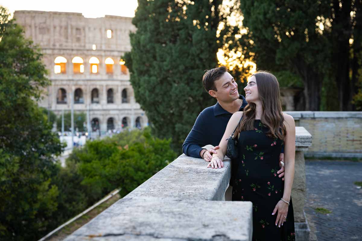 Looking back in love during a photography session in a park over the railing at sundown photos